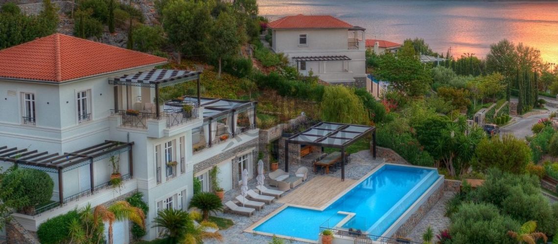 Lasithi, Elounda. For sale is a luxurious 623 sq m villa on a 4,125 sq m plot with a private heated 60 sq m pool, just 80 meters from the sea. property first image